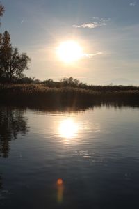 Scenic view of lake against sky during sunset