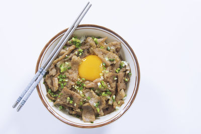 High angle view of food in bowl against white background