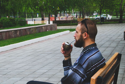 Young man smoking cigarette outdoors