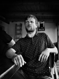 Portrait of young man sitting at home