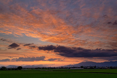 Scenic view of field against sky during sunset