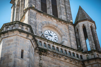 Low angle view of clock tower against sky