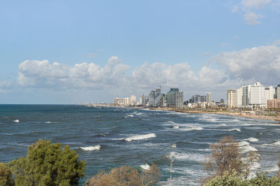Scenic view of sea and buildings against sky