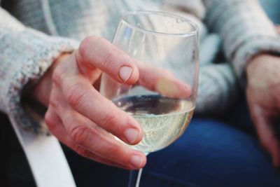 Close-up of man holding wineglass