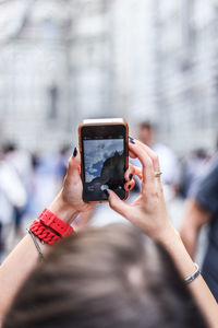 Woman photographing through smart phone