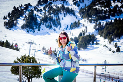 Portrait of smiling woman showing thumbs up