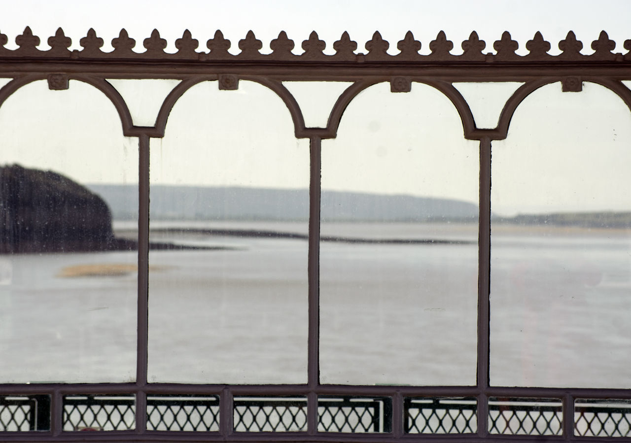 SCENIC VIEW OF RIVER SEEN THROUGH RAILING