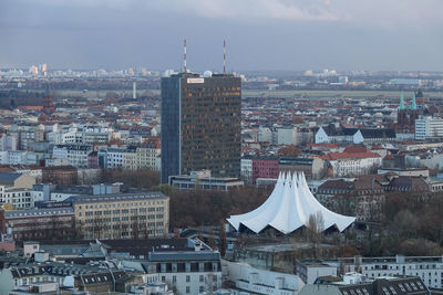 High angle view of buildings in town against sky