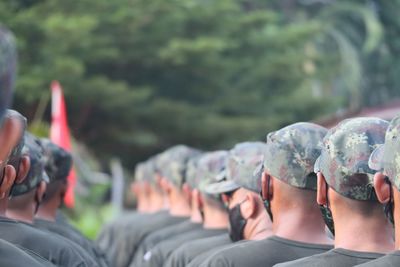 Rear view of soldiers standing outdoors