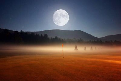 Scenic view of mountains against sky at night