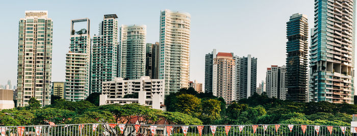 Buildings in city against clear sky