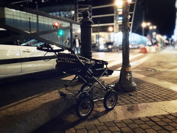 Bicycle parked on sidewalk at night