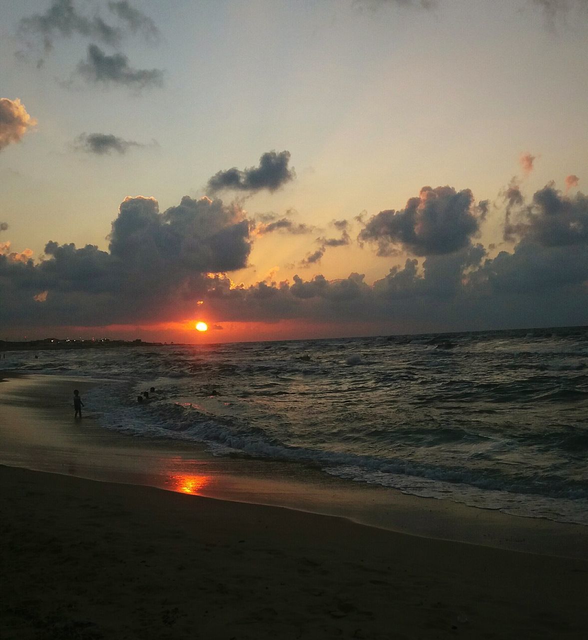 sea, sunset, beach, water, horizon over water, scenics, sun, tranquil scene, shore, beauty in nature, sky, tranquility, idyllic, cloud - sky, majestic, wave, nature, seascape, travel destinations, non-urban scene, tide, tourism, calm, back lit, vacations, cloud, coastline, atmosphere, moody sky, remote