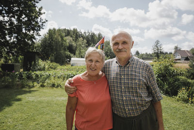 Portrait of happy senior couple standing in the garden