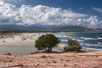 View of beach against cloudy sky