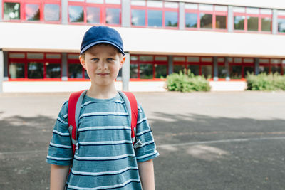 Back to school. portrait of a schoolboy boy with a backpack on his back in front of the school 