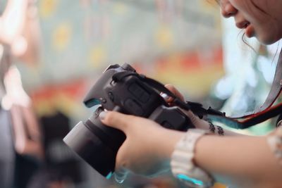Close-up of hands holding camera