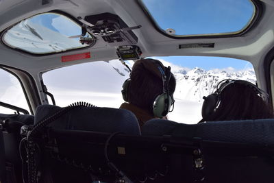 Rear view of people in cockpit during winter