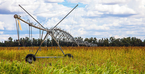 Traditional windmill on field against sky