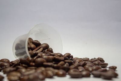 Close-up of roasted coffee beans against white background