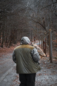 Rear view of man standing in forest