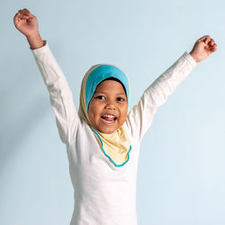 Portrait of happy boy against white background