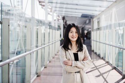 Portrait of confident chinese business woman in building office. technology