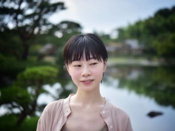 Portrait of smiling woman standing outdoors