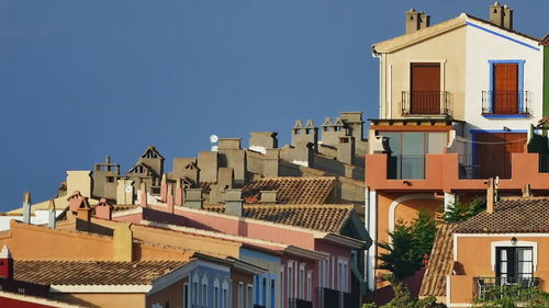 Low angle view of residential buildings against blue sky