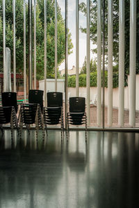 Empty chairs and table by window