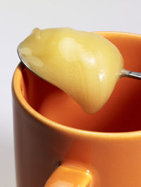 Close-up of yellow drink against white background