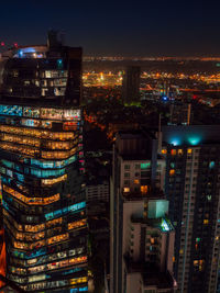 Bangkok highrise office building and apartment with light illumination at night time.