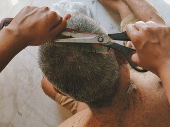 High angle view of man working/ grooming hair
