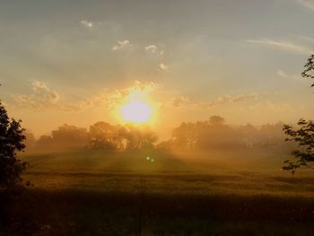 Scenic view of field against sky during sunset