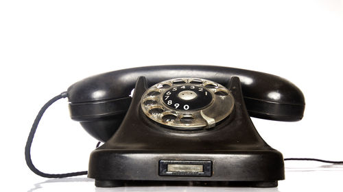 Close-up of telephone booth against white background