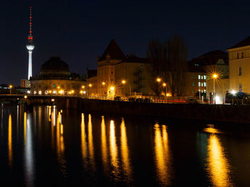 Illuminated city at waterfront