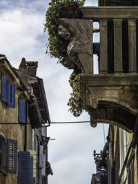 Low angle view of statues on building against sky