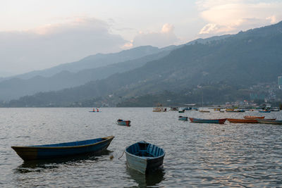 Scenic view of sea and mountains against sky