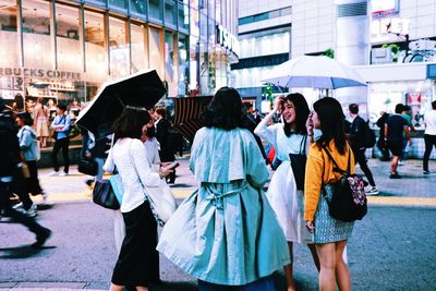 People walking on street in city