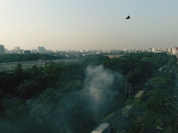 Aerial view of city against clear sky