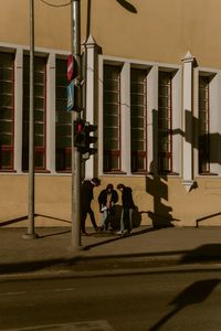 People walking on street against buildings in city