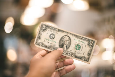 Close-up of hand holding paper