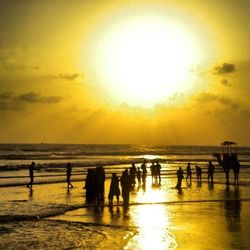 People on beach at sunset