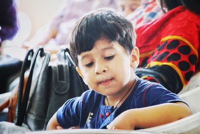 Close-up of boy sitting outdoors