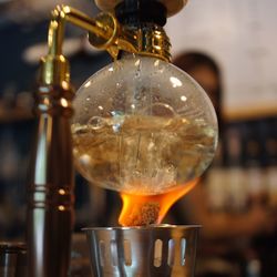 Close-up of tea light candles on glass