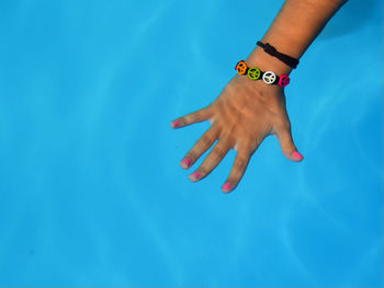 Midsection of woman swimming in pool