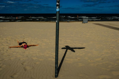 Person on beach against sky