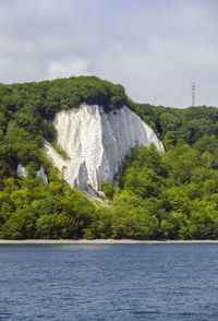 Scenic view of waterfall against sky