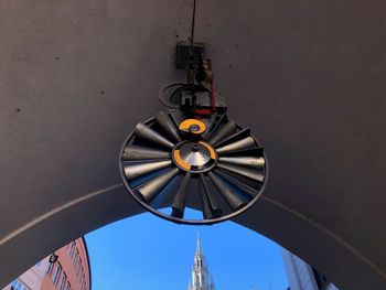 Low angle view of lighting equipment hanging against ceiling