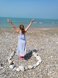 Full length of woman at beach against sky